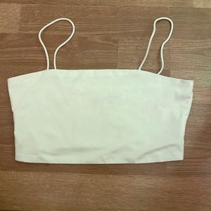 Soft and comfortable spaghetti strap tank top. White, cropped, double lined.